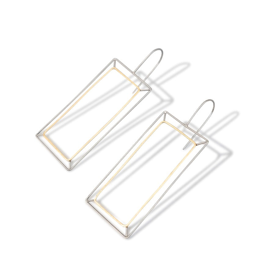 Gold Frame Earrings by Eleanor Whitworth, a pair of oblong silver wire earrings with a gold wire insert. | Contemporary jewellery at The Biscuit Factory Newcastle