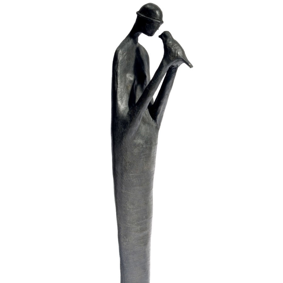 Fly Free by Jennifer Watt, a slate resin sculpture of a figure holding a bird. | Original sculpture for sale at The Biscuit Factory Newcastle.