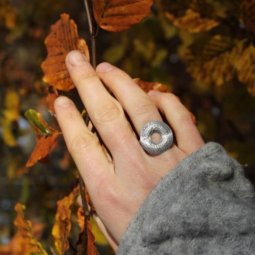 Torus Ring by Caitlin Hegney, a silver cirlcle on a silver band. | Handmade jewellery for sale at The Biscuit Factory Newcastle